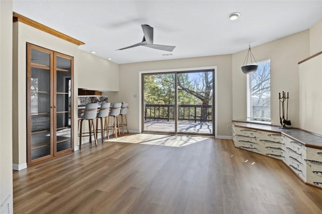 interior space with recessed lighting, baseboards, a ceiling fan, and wood finished floors