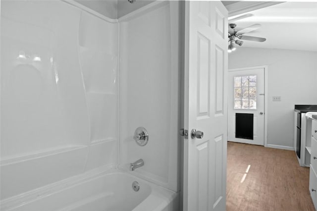 full bathroom featuring ceiling fan, shower / bath combination, lofted ceiling, and wood finished floors