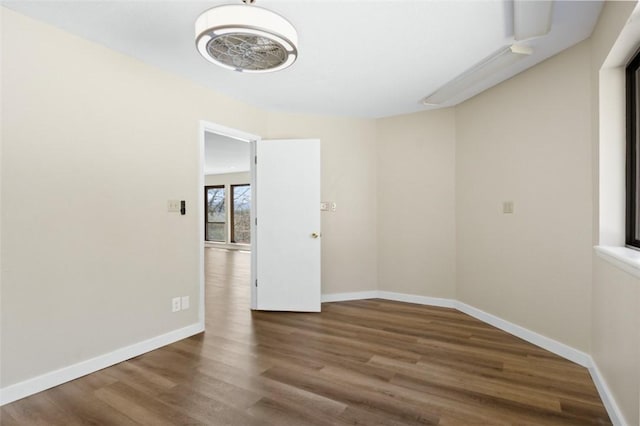 unfurnished room featuring wood finished floors and baseboards