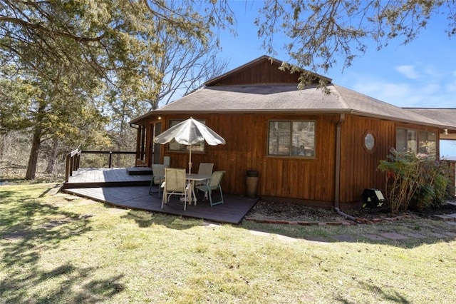 back of house featuring a yard and a deck