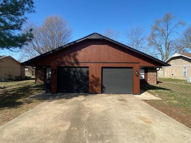 garage with concrete driveway