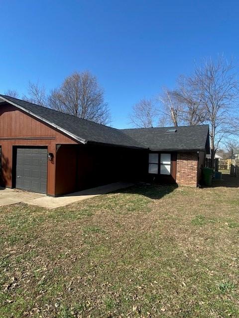 view of side of property with a lawn