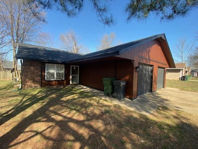 back of property featuring a yard and an attached garage