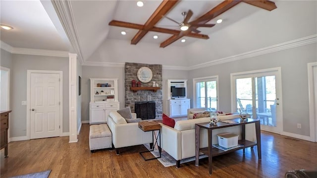 living area featuring wood finished floors, a stone fireplace, ceiling fan, and ornamental molding