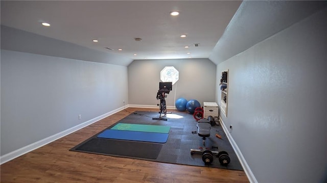 exercise room featuring recessed lighting, baseboards, lofted ceiling, and wood finished floors