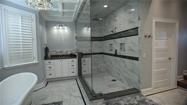 full bath with a freestanding tub, marble finish floor, a stall shower, and an inviting chandelier