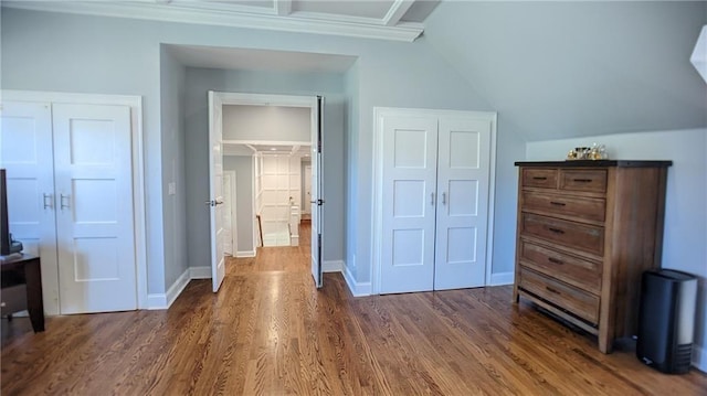 bedroom with dark wood finished floors, a closet, and baseboards