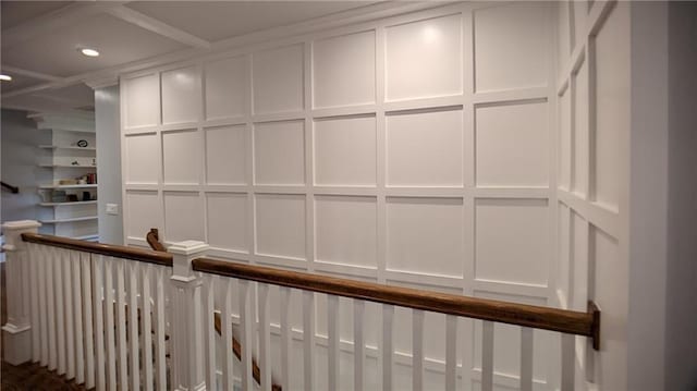 interior space with a decorative wall, recessed lighting, coffered ceiling, and built in features