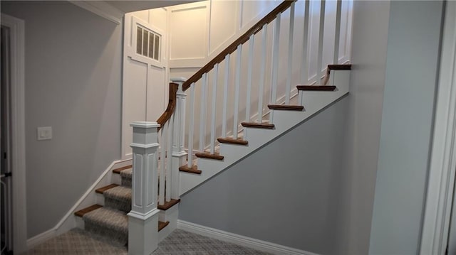 stairs with baseboards, visible vents, and carpet floors