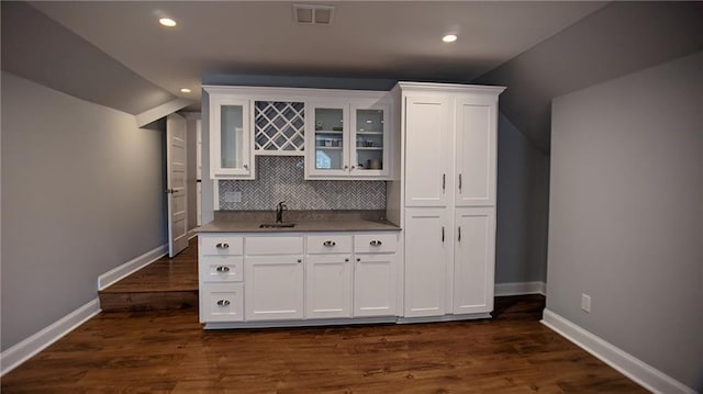 bar featuring indoor wet bar, visible vents, tasteful backsplash, and baseboards