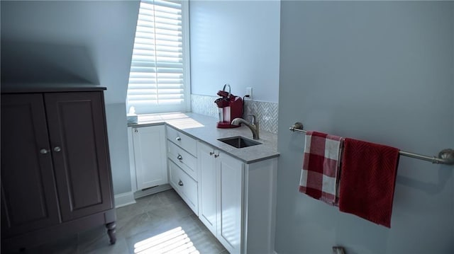 bathroom with tile patterned flooring and a sink