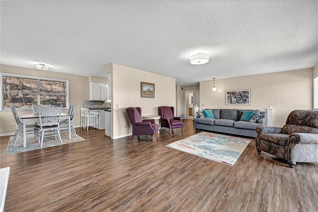 living area featuring a textured ceiling and wood finished floors