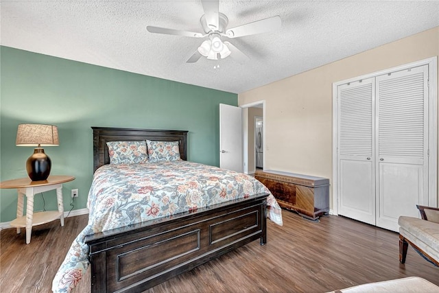 bedroom featuring baseboards, wood finished floors, a closet, and a textured ceiling