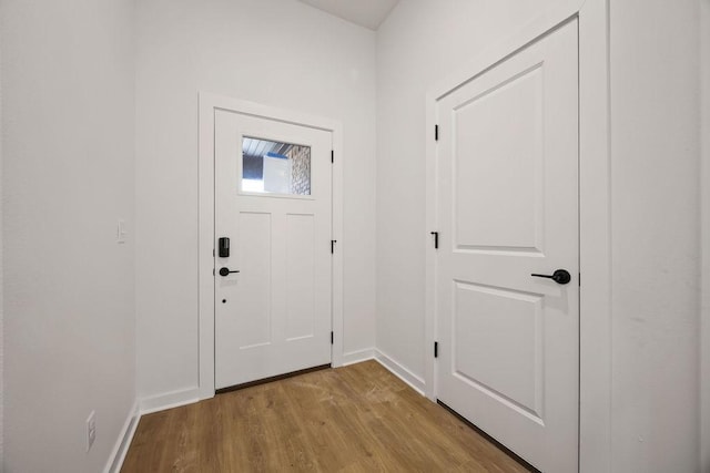 entryway with baseboards and wood finished floors