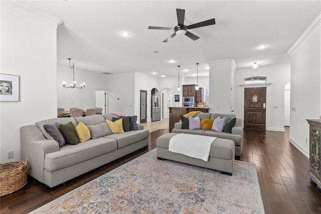 living room featuring arched walkways, dark wood-style floors, ceiling fan with notable chandelier, and crown molding