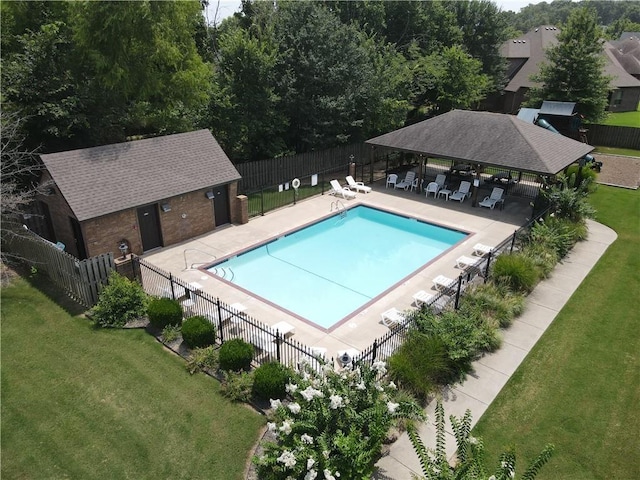 community pool featuring a gazebo, a yard, a patio area, and fence