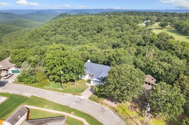 birds eye view of property featuring a wooded view