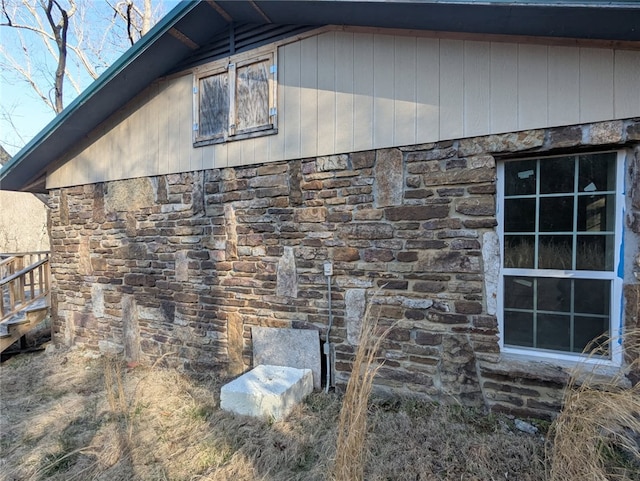 view of side of property featuring stone siding