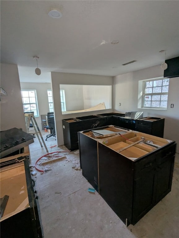 kitchen featuring a kitchen island and dark cabinetry