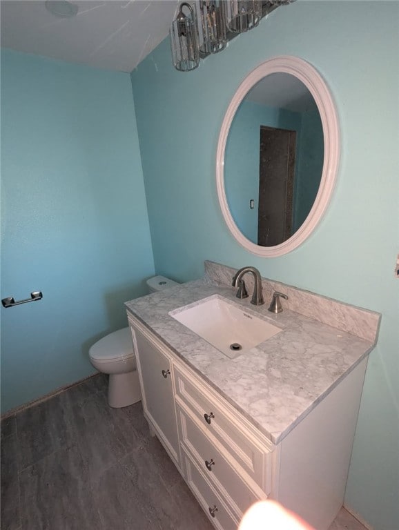 half bathroom featuring toilet and vanity