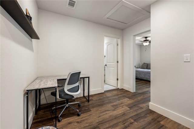 office with visible vents, baseboards, attic access, and dark wood finished floors