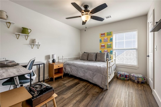 bedroom featuring dark wood-style floors, visible vents, and ceiling fan