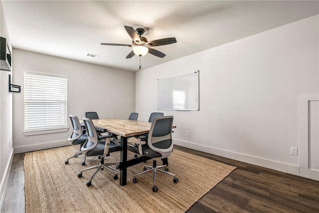 office featuring ceiling fan, visible vents, baseboards, and wood finished floors