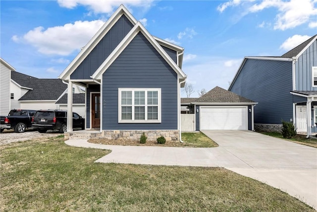 view of front facade featuring a front yard, a garage, board and batten siding, and driveway