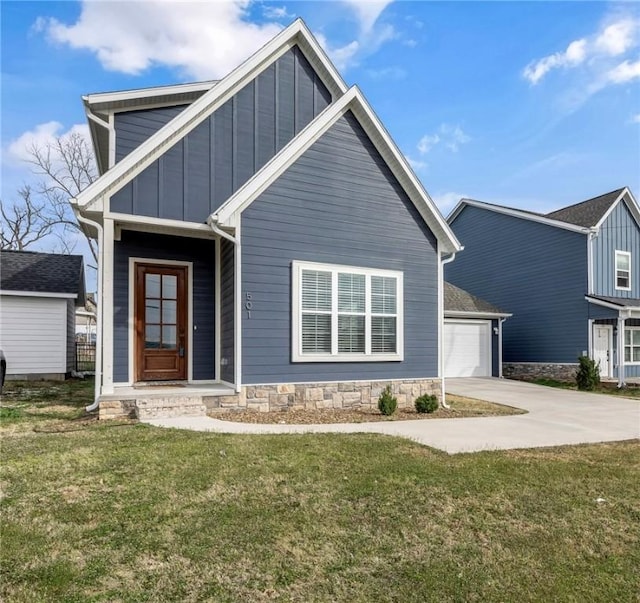 view of front of property with a front yard, an attached garage, board and batten siding, and driveway