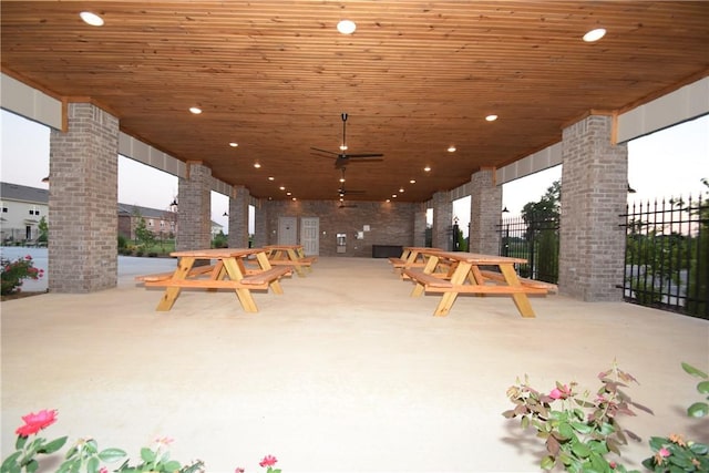 view of patio featuring a ceiling fan and fence