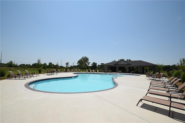 community pool with a patio area