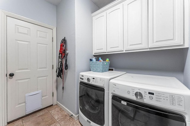 laundry room with cabinet space, washing machine and dryer, and baseboards