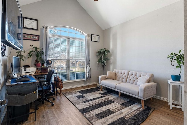 office area with high vaulted ceiling, baseboards, and wood finished floors