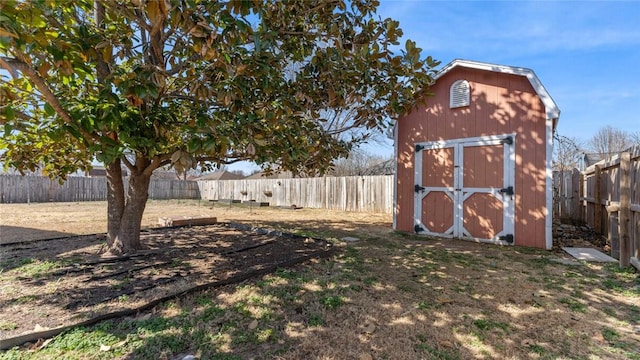 view of yard featuring a fenced backyard, an outdoor structure, and a shed