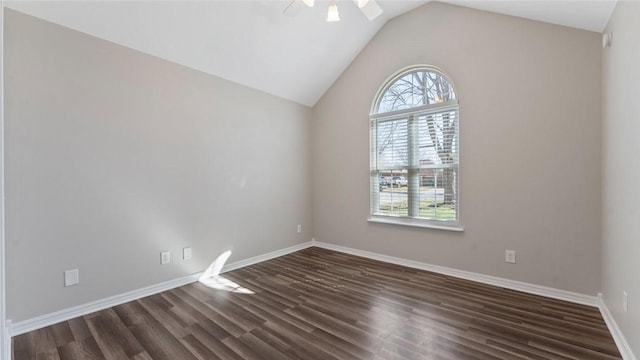 empty room with dark wood-type flooring, a ceiling fan, and vaulted ceiling