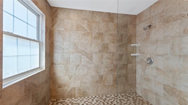 bathroom featuring tiled shower and a healthy amount of sunlight