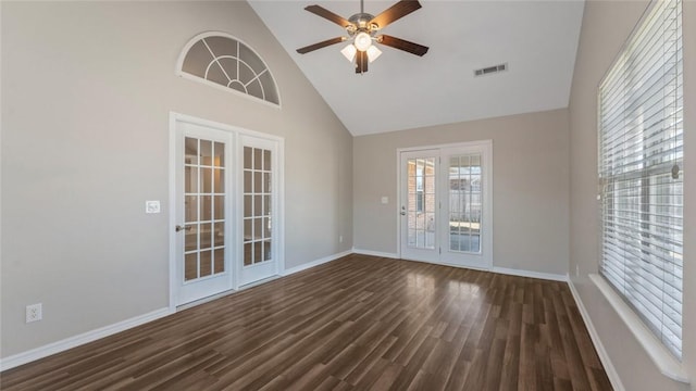 unfurnished room with visible vents, high vaulted ceiling, dark wood-type flooring, and ceiling fan