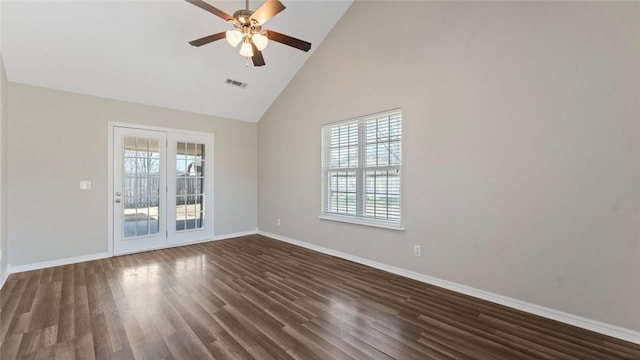 empty room with a ceiling fan, visible vents, baseboards, high vaulted ceiling, and dark wood finished floors