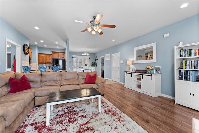 living area with wood finished floors, recessed lighting, a ceiling fan, and baseboards