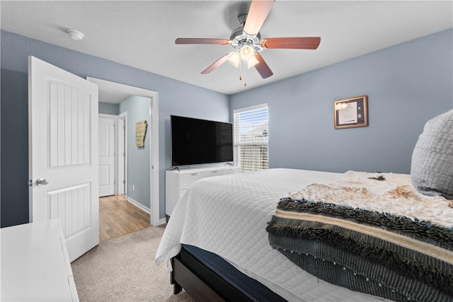 carpeted bedroom featuring baseboards and ceiling fan