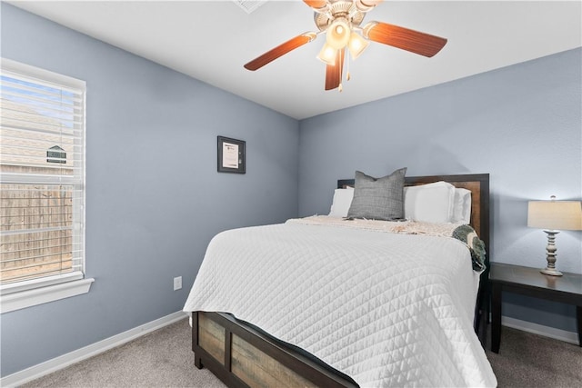 carpeted bedroom featuring a ceiling fan and baseboards