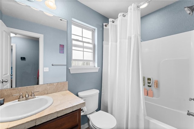 bathroom with toilet, shower / bath combo with shower curtain, and vanity