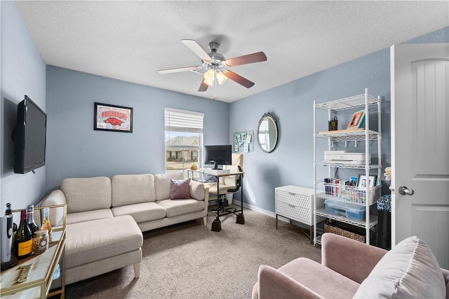 carpeted living room featuring baseboards and a ceiling fan