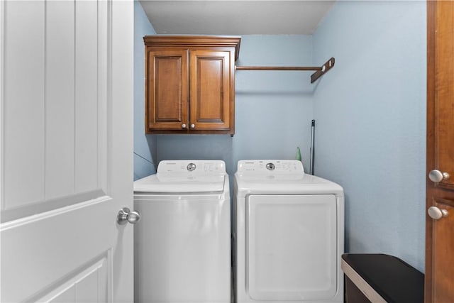 laundry area featuring cabinet space and washing machine and clothes dryer