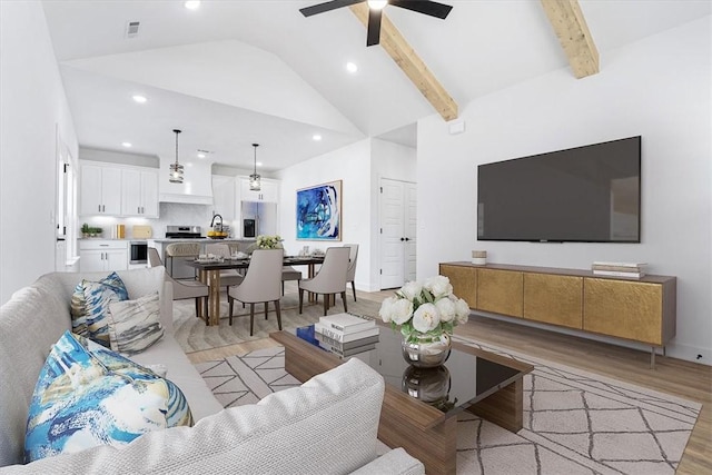 living area with visible vents, lofted ceiling with beams, recessed lighting, light wood finished floors, and ceiling fan