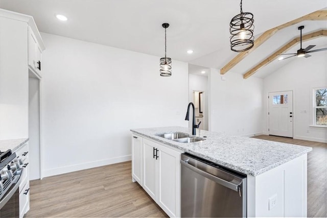 kitchen featuring vaulted ceiling with beams, open floor plan, light wood-style flooring, stainless steel appliances, and a sink