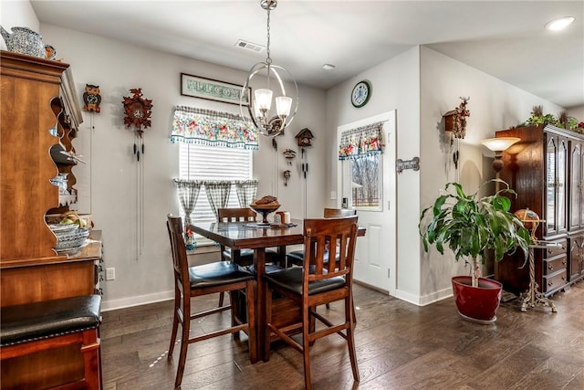 dining area with dark wood-style floors, visible vents, a notable chandelier, and baseboards