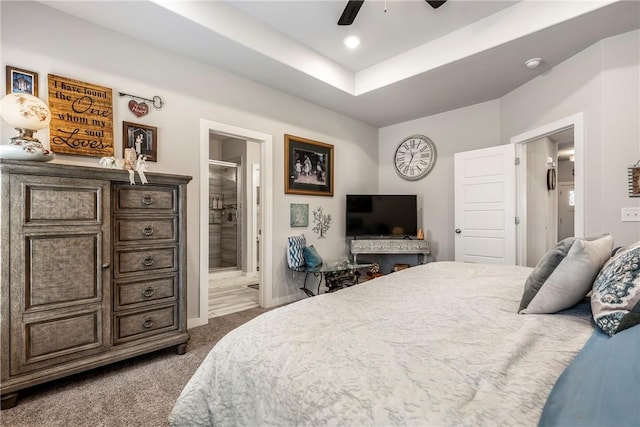 bedroom featuring ensuite bathroom, a ceiling fan, a tray ceiling, recessed lighting, and carpet flooring