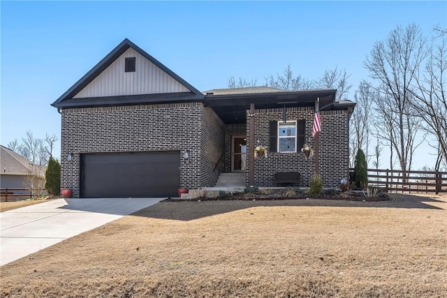 view of front of house with brick siding, fence, a garage, and driveway