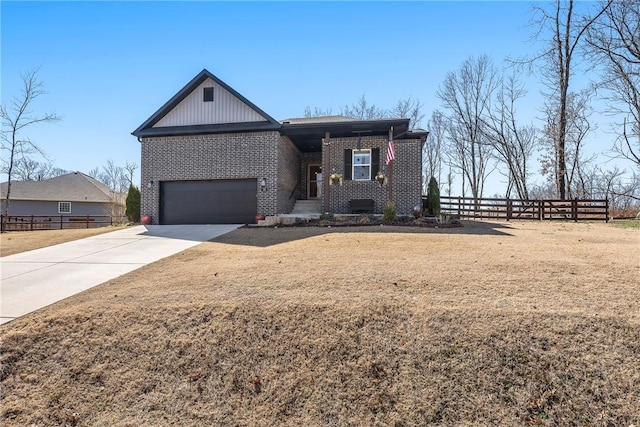 view of front of property with a front lawn, fence, concrete driveway, a garage, and brick siding